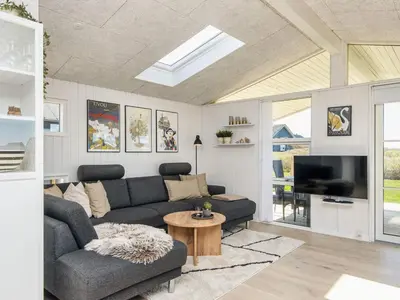 a living room with a couch and a tv at 6 person holiday home in Lemvig in Lemvig