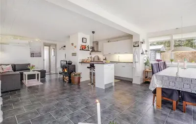 a kitchen and a living room with a table at Two-Bedroom Holiday Home In Spottrup in Spottrup