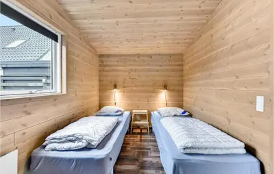 two beds in a sauna with a window at Five-Bedroom Holiday Home In Blokhus in Blokhus