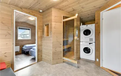 a laundry room with a washer and dryer at Five-Bedroom Holiday Home In Blokhus in Blokhus