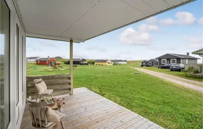 a porch with two chairs and a view of a field at Three-Bedroom Holiday Home In Lemvig in Lemvig