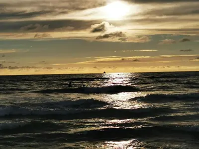a sun setting over the ocean with waves at Seaside Serenity in Blokhus-By Traum in Blokhus