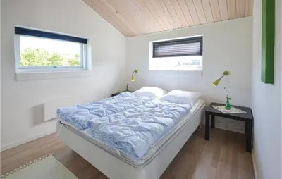 a bed in a white room with a window at Three-Bedroom Holiday Home In Vestervig in Vestervig