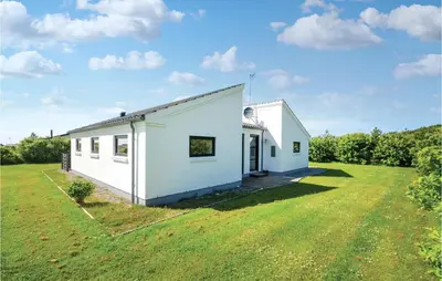 a white house with a large grassy yard at Three-Bedroom Holiday Home In Vestervig in Vestervig