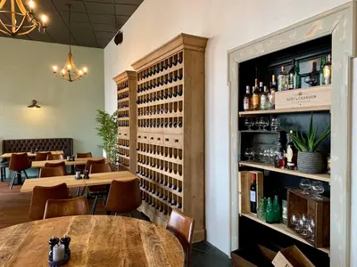 a restaurant with tables and chairs and a bar at Hotel Schaumburg in Holstebro