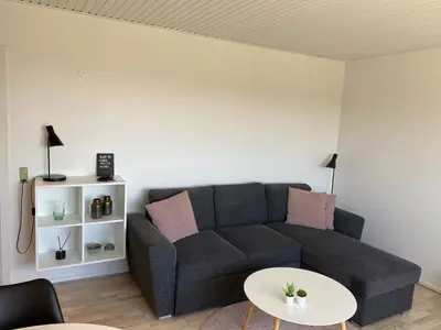 a living room with a couch and a table at Malthe Bruuns Vej 17, 1. sal in Thisted