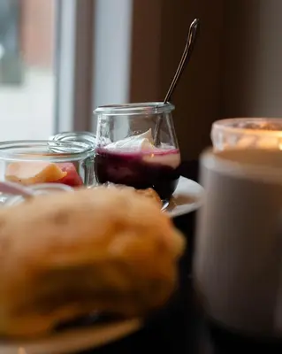 a table topped with food and a cup of coffee at Struer Grand Hotel in Struer