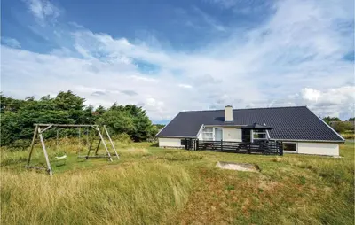 a house with a playground in front of it at Five-Bedroom Holiday Home In Thisted in Thisted