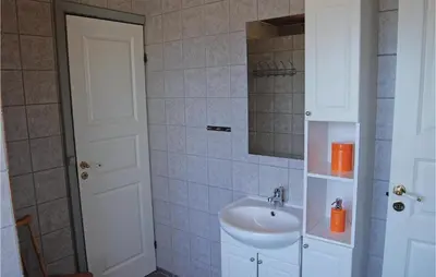 a bathroom with a sink and a mirror at Five-Bedroom Holiday Home In Thisted in Thisted