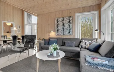 a living room with a couch and a table at Three-Bedroom Holiday Home In Logstor in Løgstør