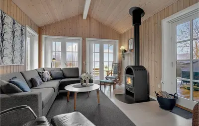 a living room with a couch and a fireplace at Three-Bedroom Holiday Home In Logstor in Løgstør