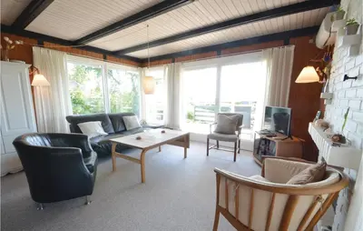 a living room with a couch and a table at Three-Bedroom Holiday Home In Hurup Thy in Doverodde