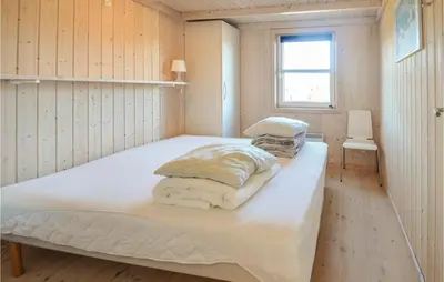 a bedroom with a large white bed in a room at Four-Bedroom Holiday Home In Fjerritslev in Fjerritslev