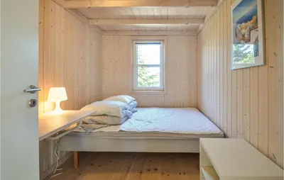 a small bedroom with a bed and a window at Four-Bedroom Holiday Home In Fjerritslev in Fjerritslev