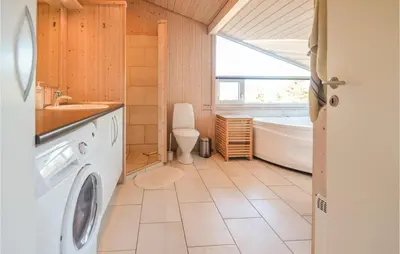 a bathroom with a sink and a washing machine at Four-Bedroom Holiday Home In Fjerritslev in Fjerritslev