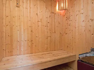 a sauna with a bench in a wooden wall at 6 person holiday home in Farsø-By Traum in Farsø