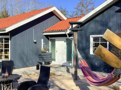 a hammock in front of a black building at Spacious Family Retreat - By Traum Ferienwohnungen in Skals