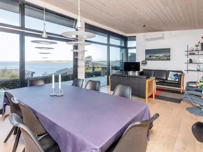 a dining room with a purple table and chairs at Modern Retreat with View - By Traum Ferienwohnungen in Løgstrup