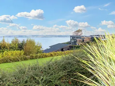 a house on the shore of a body of water at Modern Retreat with View - By Traum Ferienwohnungen in Løgstrup