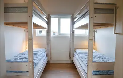 two bunk beds in a room with a window at Three-Bedroom Holiday Home In Lemvig in Lemvig