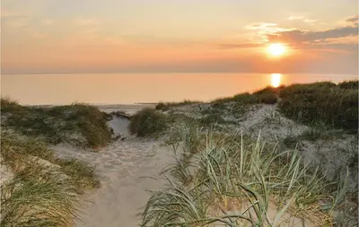 a sunset over a sandy beach with the ocean at Three-Bedroom Holiday Home In Lemvig in Lemvig