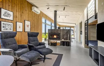 a living room with chairs and a fireplace at Two-Bedroom Holiday Home In Vinderup in Vinderup
