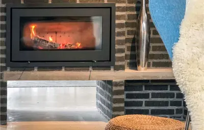 a fireplace with a fire place in a room at Two-Bedroom Holiday Home In Vinderup in Vinderup