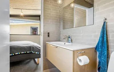 a bathroom with a sink and a bed at Two-Bedroom Holiday Home In Vinderup in Vinderup