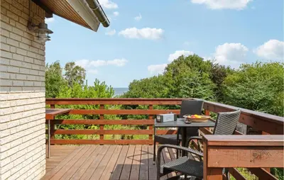 a patio with a table and chairs on a deck at Three-Bedroom Holiday Home In Fur in Fur
