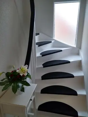 a stairway with black and white risers and a flower at Bed and Breakfast i Struer in Struer