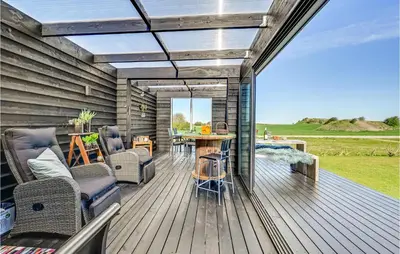 a patio with chairs and a table on a deck at Two-Bedroom Holiday Home In Lemvig in Lemvig