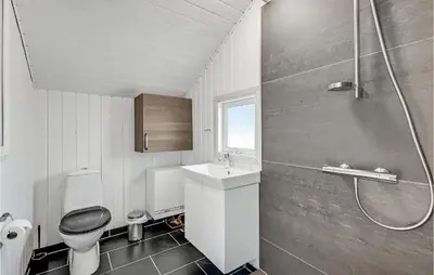 a bathroom with a toilet and a sink and a shower at Two-Bedroom Holiday Home In Lemvig in Lemvig