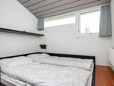 a bedroom with two beds in front of a window at 6 person holiday home in Brovst-By Traum in Brovst