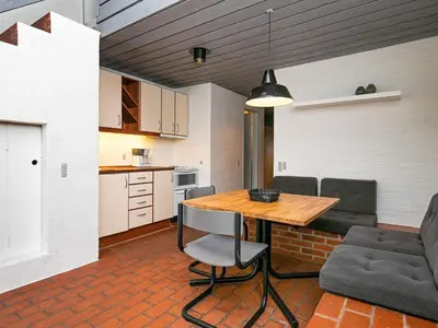 a kitchen and dining room with a table and chairs at 6 person holiday home in Brovst-By Traum in Brovst