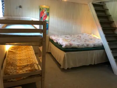 a room with two bunk beds and a staircase at 