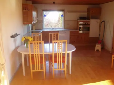 a kitchen with a table and chairs and a kitchen with a window at 