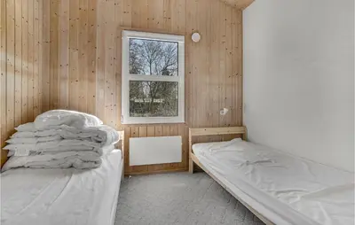 a bedroom with two beds and a window at Cozy Home In Roslev With Wifi in Roslev