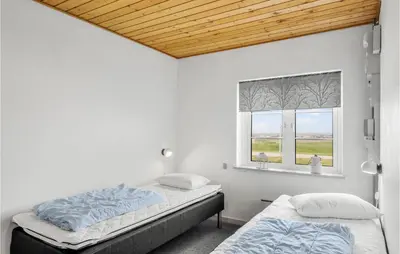 a bedroom with two beds and a window at Two-Bedroom Apartment In Lemvig in Lemvig
