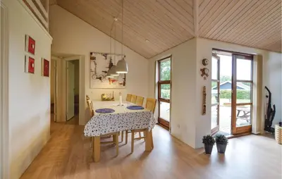 a dining room with a table and chairs at Three-Bedroom Holiday Home In Vinderup in Vinderup