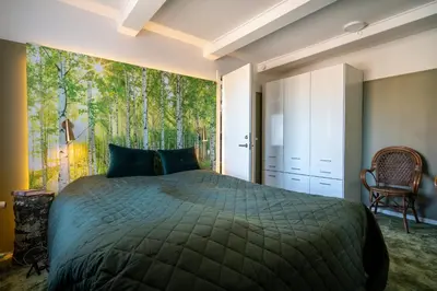 a bedroom with a bed and a large window at Klitmøller Hotel in Klitmøller
