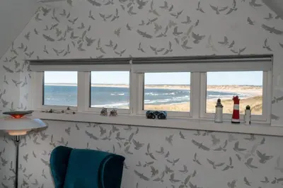 a window in a room with a view of the ocean at Klitmøller Hotel in Klitmøller