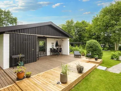 a backyard deck with a black and white shed at 5 person holiday home in Vinderup-By Traum in Vinderup