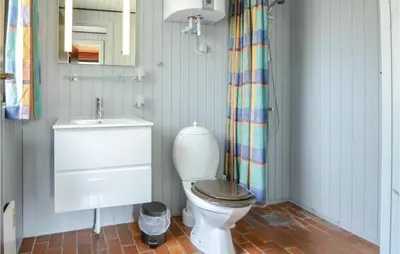 a bathroom with a toilet and a sink at Three-Bedroom Holiday Home In Hurup Thy in Sindrup