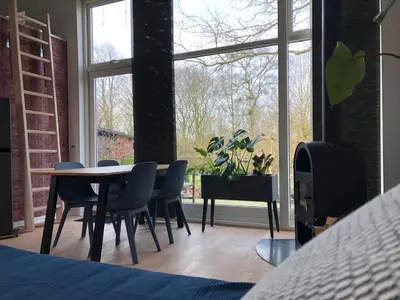 a bedroom with a table and chairs and a window at Fly B&B in Skive