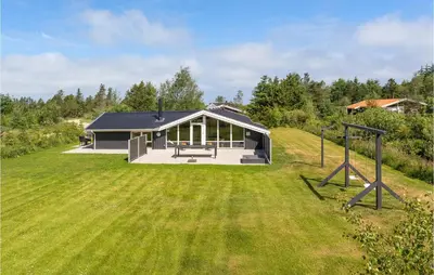 a house with a large yard in front of it at Four-Bedroom Holiday Home In Fjerritslev in Fjerritslev