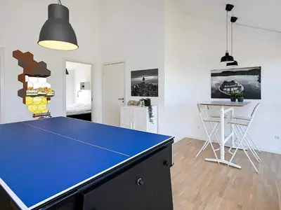 a blue ping pong table in a room at Modern Retreat with Spa - By Traum Ferienwohnungen in Løkken