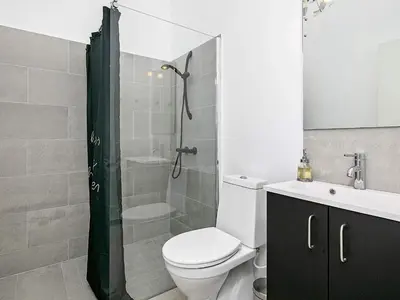 a bathroom with a toilet and a shower and a sink at Modern Retreat with Spa - By Traum Ferienwohnungen in Løkken