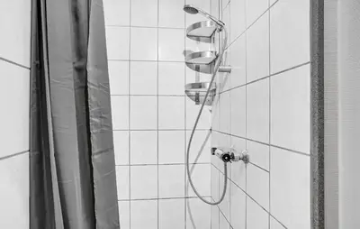 a shower with two shower heads in a bathroom at Two-Bedroom Holiday Home In Spottrup in Spottrup