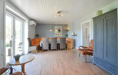 a living room with a table and chairs at Three-Bedroom Holiday Home In Vinderup in Vinderup