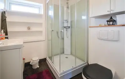 a bathroom with a shower and a toilet and a sink at Three-Bedroom Holiday Home In Vinderup in Vinderup